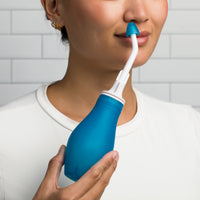 Person using the RhinoRinser reusable nasal irrigator