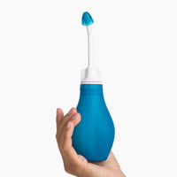 RhinoRinser sinus rinse bottle held in one hand