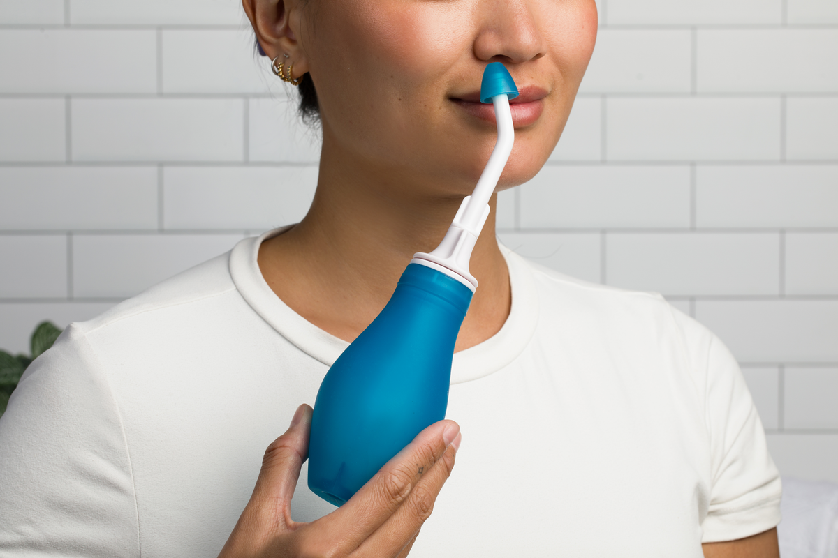 Person using the RhinoRinser reusable nasal irrigator
