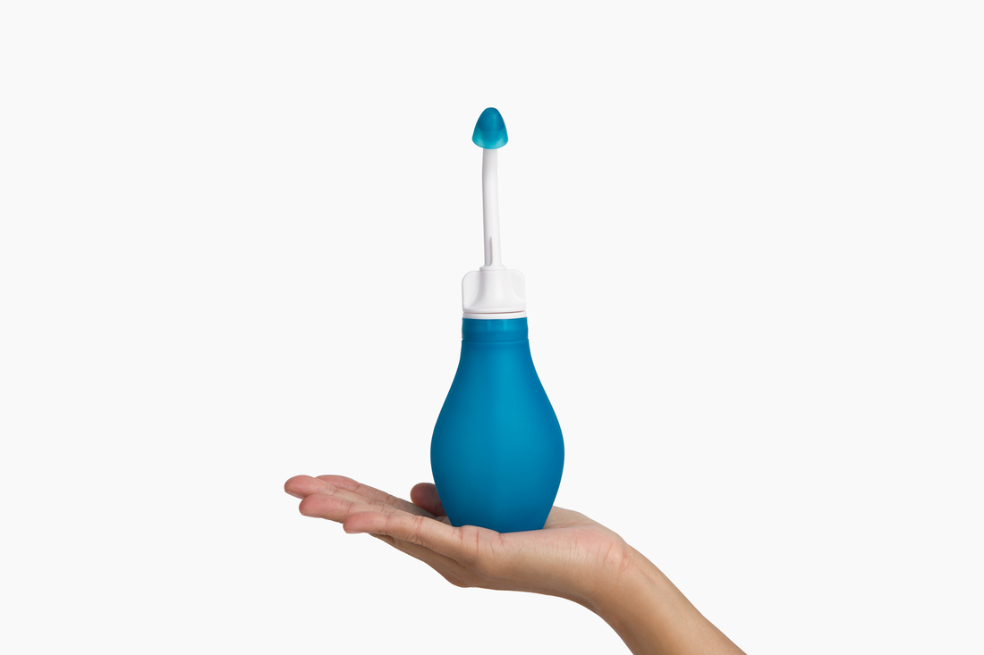 RhinoRinser sinus rinse bottle held in one hand